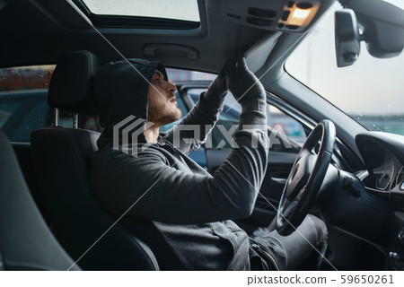 Car robber searches the interior, dangerous hobby Car robber searches the interior, dangerous hobby 59650261