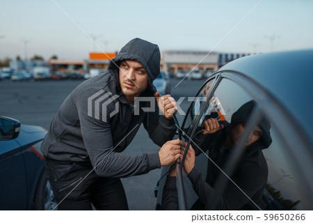 Car thief breaking door lock, criminal job 59650266