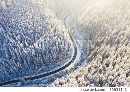 Aerial view on the road and forest at the winter time. Natural winter landscape from air. Aerial view on the road and forest at the winter time. Natural winter landscape from air. 59651142