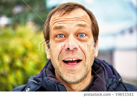 Street photo of a surprised middle-aged man. 59651581