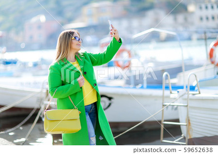Beautiful woman tourist near the yacht during the journey, calls his travel agent Beautiful woman tourist near the yacht during the journey, calls his travel agent 59652638