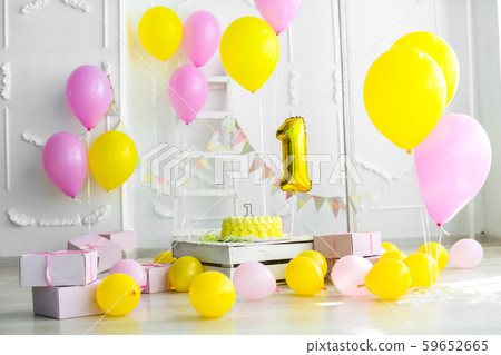 Yellow color concept of festive decorations with cake and candles 1 year Yellow color concept of festive decorations with cake and candles 1 year 59652665