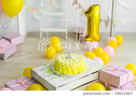 Yellow color concept of festive decorations with cake and candles 1 year Yellow color concept of festive decorations with cake and candles 1 year 59652667
