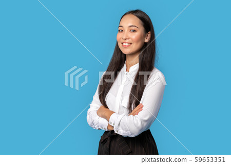 Freestyle. Young woman wearing shirt and skirt standing isolated on blue crossed arms posing Freestyle. Young woman wearing shirt and skirt standing isolated on blue crossed arms posing 59653351