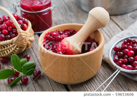 Bowl of crushed cranberries, basket of bog berries 59653606