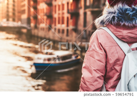 Rear crop view of adult woman tourist with backpack enjoying tourist river pleasure tour boat in Rear crop view of adult woman tourist with backpack enjoying tourist river pleasure tour boat in 59654791
