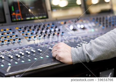 sound engineer and audio mixing console in studio 59658766