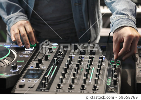 Dj playing music using modern Dj controller 59658769