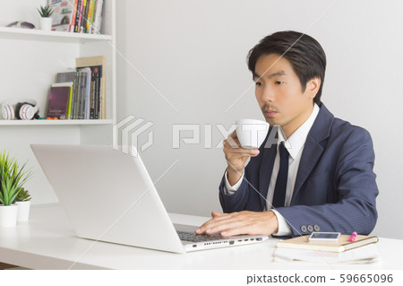 Asian Financial Advisor or Asian Consulting Businessman Drinking Coffee Asian Financial Advisor or Asian Consulting Businessman Drinking Coffee 59665096