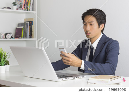Asian Financial Advisor or Asian Consulting Businessman Contact with Customer by Smartphone Asian Financial Advisor or Asian Consulting Businessman Contact with Customer by Smartphone 59665098