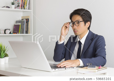 Asian Financial Advisor or Asian Consulting Businessman Consider Data Asian Financial Advisor or Asian Consulting Businessman Consider Data 59665101