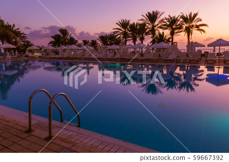 Swimming pool on Cyprus island at sunset Swimming pool on Cyprus island at sunset 59667392