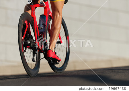 Racing bike detail on gear wheels and feet Racing bike detail on gear wheels and feet 59667488