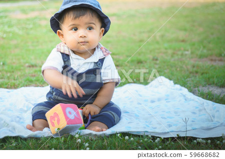 Cute little asian baby sitting in garden,vintage 59668682