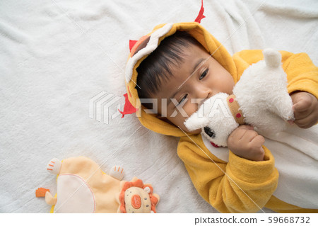 Cute asian baby lying and play teddy dog 59668732