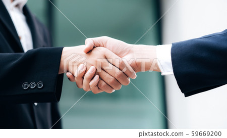 Businessmans handshake after good deal. Businessmans handshake after good deal. 59669200