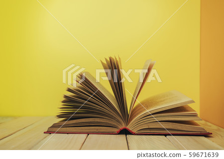 Beautiful book on a wooden table and yellow orange Beautiful book on a wooden table and yellow orange 59671639