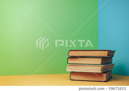 Beautiful open book on a yellow table and blue 59671653