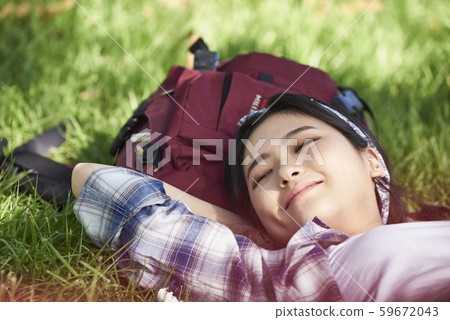 Woman lying on the grass 59672043