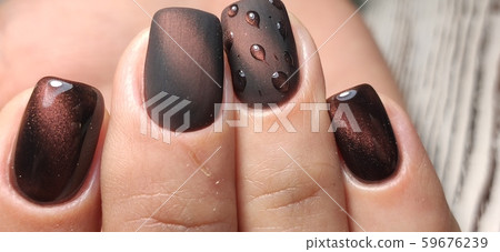 Gray striped nail design on female hand close up. 59676239