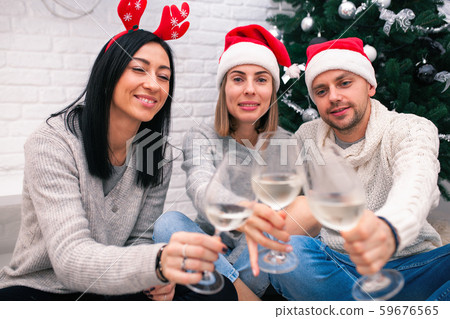 Happy friends celebrating New Year in home Happy friends celebrating New Year in home 59676565