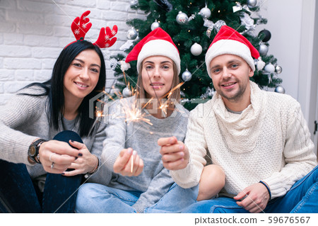 Happy friends celebrating New Year in home Happy friends celebrating New Year in home 59676567
