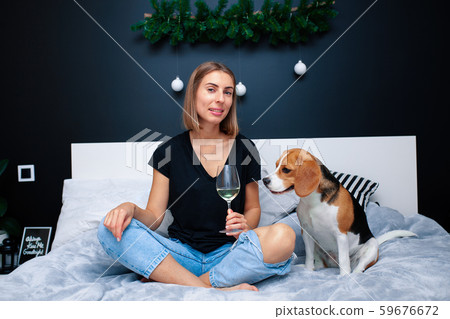 Young beautiful woman playing with dog sitting on Young beautiful woman playing with dog sitting on 59676672