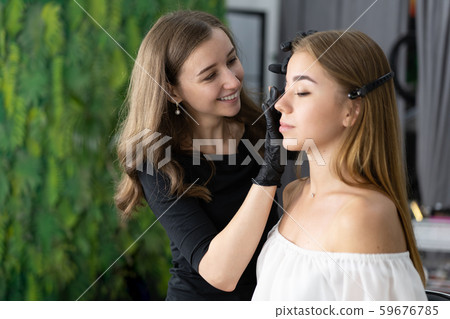 Young beautician caucasian girl holds model Young beautician caucasian girl holds model 59676785