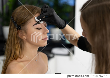 Young beautician caucasian girl holds model Young beautician caucasian girl holds model 59676786