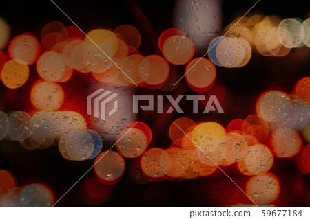 Rain drops on window with road light bokeh in 59677184