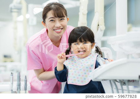 Dental hygienist and child 59677828