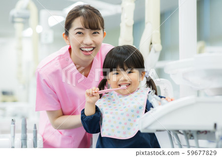 Dental hygienist and child Dental hygienist and child 59677829