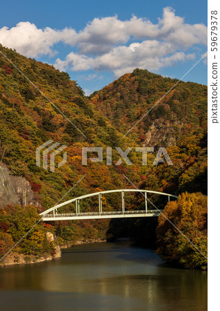 Mizugaki Lake Masutomi Bridge, autumn leaves and blue sky Mizugaki Lake Masutomi Bridge, autumn leaves and blue sky 59679378