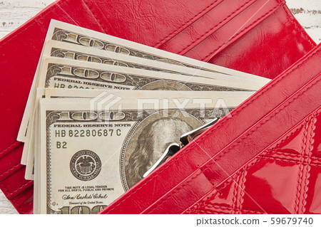 Close-up of dollars in a red women's purse. Close-up of dollars in a red women's purse. 59679740