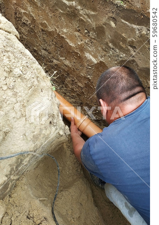 The contractor installs a sewer in a ditch and 59680542