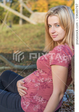 Side view of sitting young pregnant woman 59680797