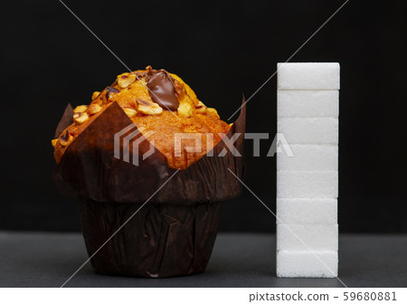 sugar level next to the cupcake, cubes sugar 59680881