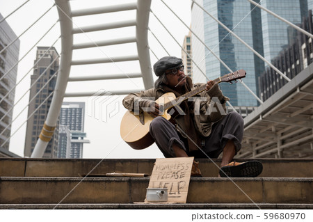 Old beggar play music for money 59680970