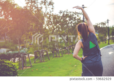 Women exercising. Young fitness woman exercising in the morning at the public park. Women exercising. Young fitness woman exercising in the morning at the public park. 59682929