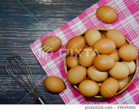 the eggs in a basket place on pink fabric on a black background the eggs in a basket place on pink fabric on a black background 59684066
