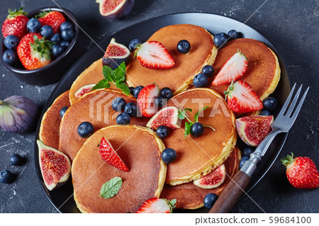 almond pancakes on a black plate, close-up 59684100