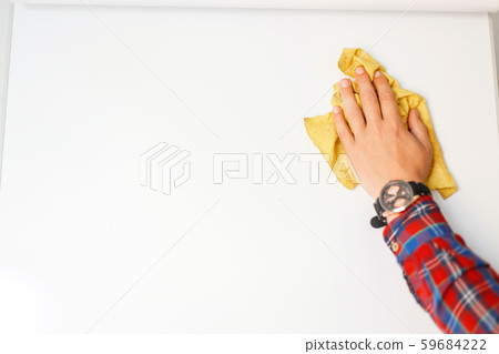 man's hand with a rag is cleaning a white board man's hand with a rag is cleaning a white board 59684222