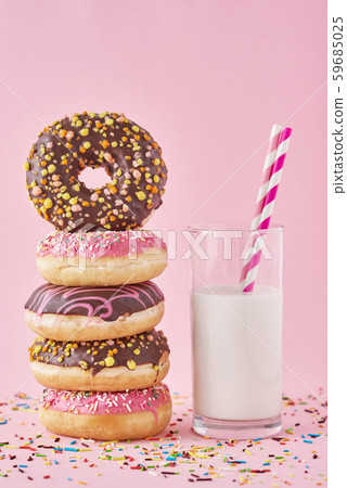 colorful donuts glazes with sprinkles and glass of milk colorful donuts glazes with sprinkles and glass of milk 59685025