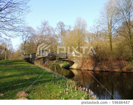 Stone bridge over canal in park. Spring Stone bridge over canal in park. Spring 59686487