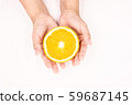 Organic freshness Orange cutting on kid hand Isolated white background 59687145