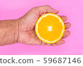 Organic freshness Orange cutting on male hand Isolated white background 59687146