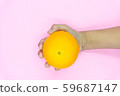 Organic freshness Orange cutting on kid hand Isolated pink background 59687147