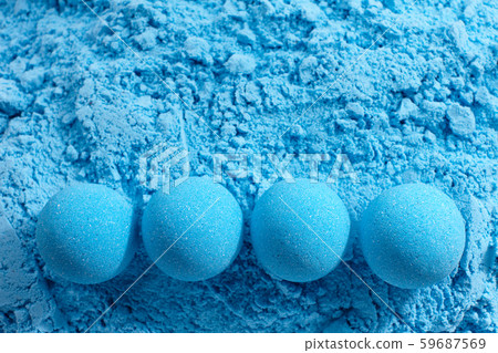 Blue bath bombs on dry mixture background Blue bath bombs on dry mixture background 59687569