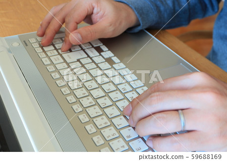 Close-up of hand entering numeric keypad on laptop keyboard 59688169