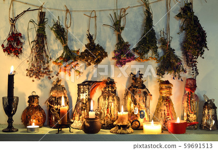 Still life with witch bottles, burning candles, healing herbs and flowers. Still life with witch bottles, burning candles, healing herbs and flowers. 59691513
